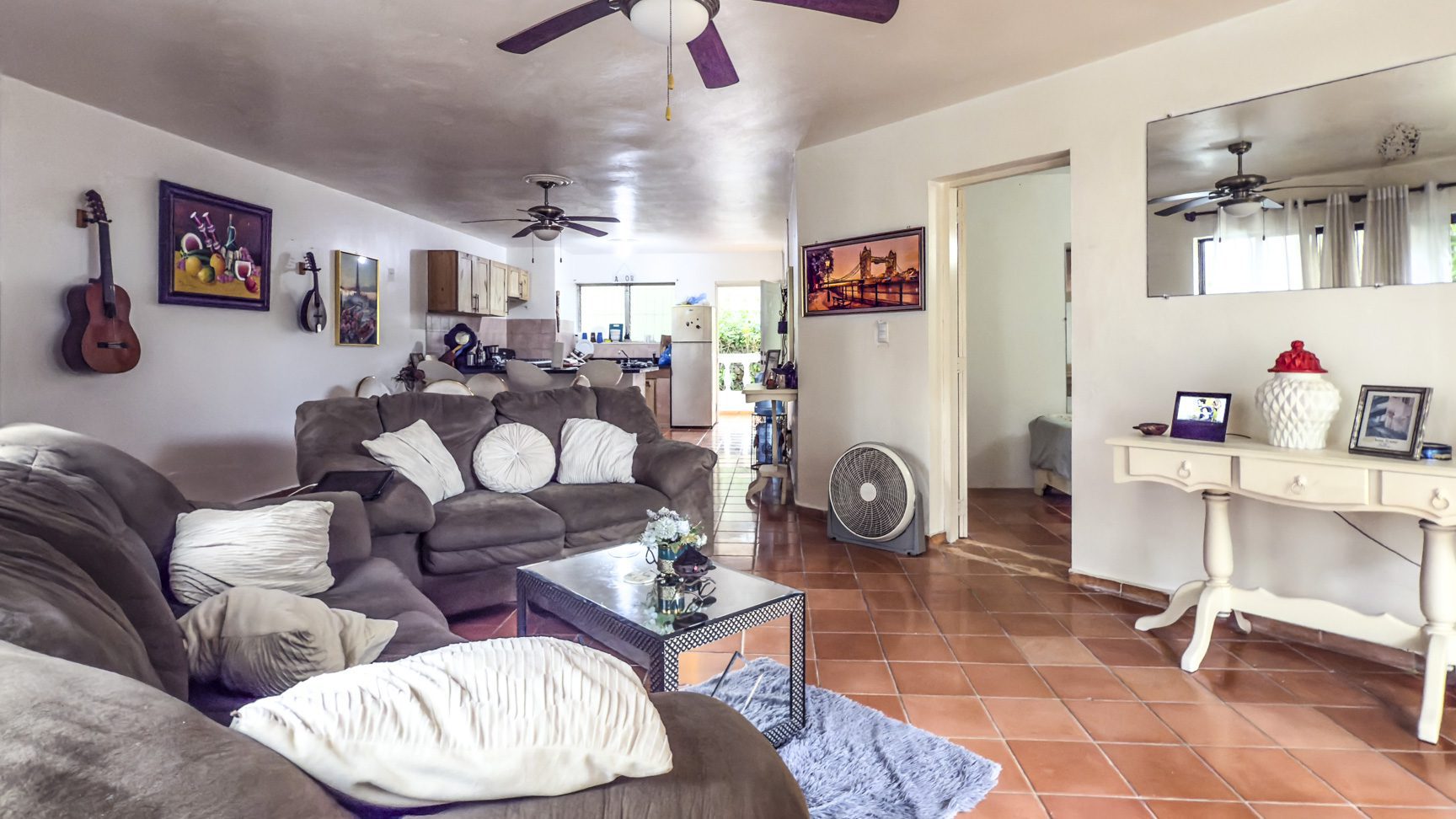 buyDRproperty Sosúa home interior with living room, kitchen, and dining area. Great value playa property. Sosua Real Estate