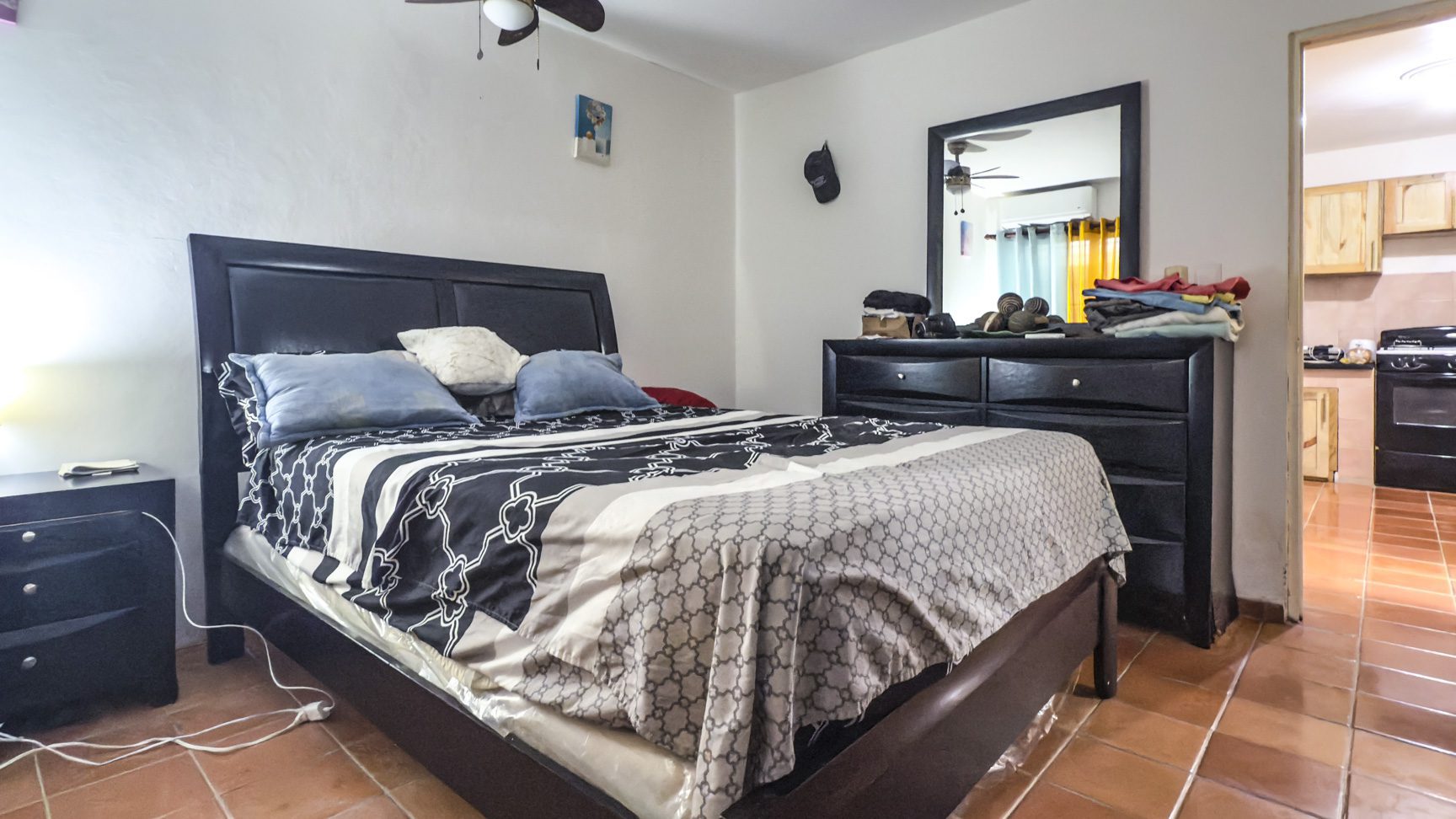 buyDRproperty Bedroom with bed, dresser, and view into kitchen. Great value Sosúa property. Sosua Real Estate