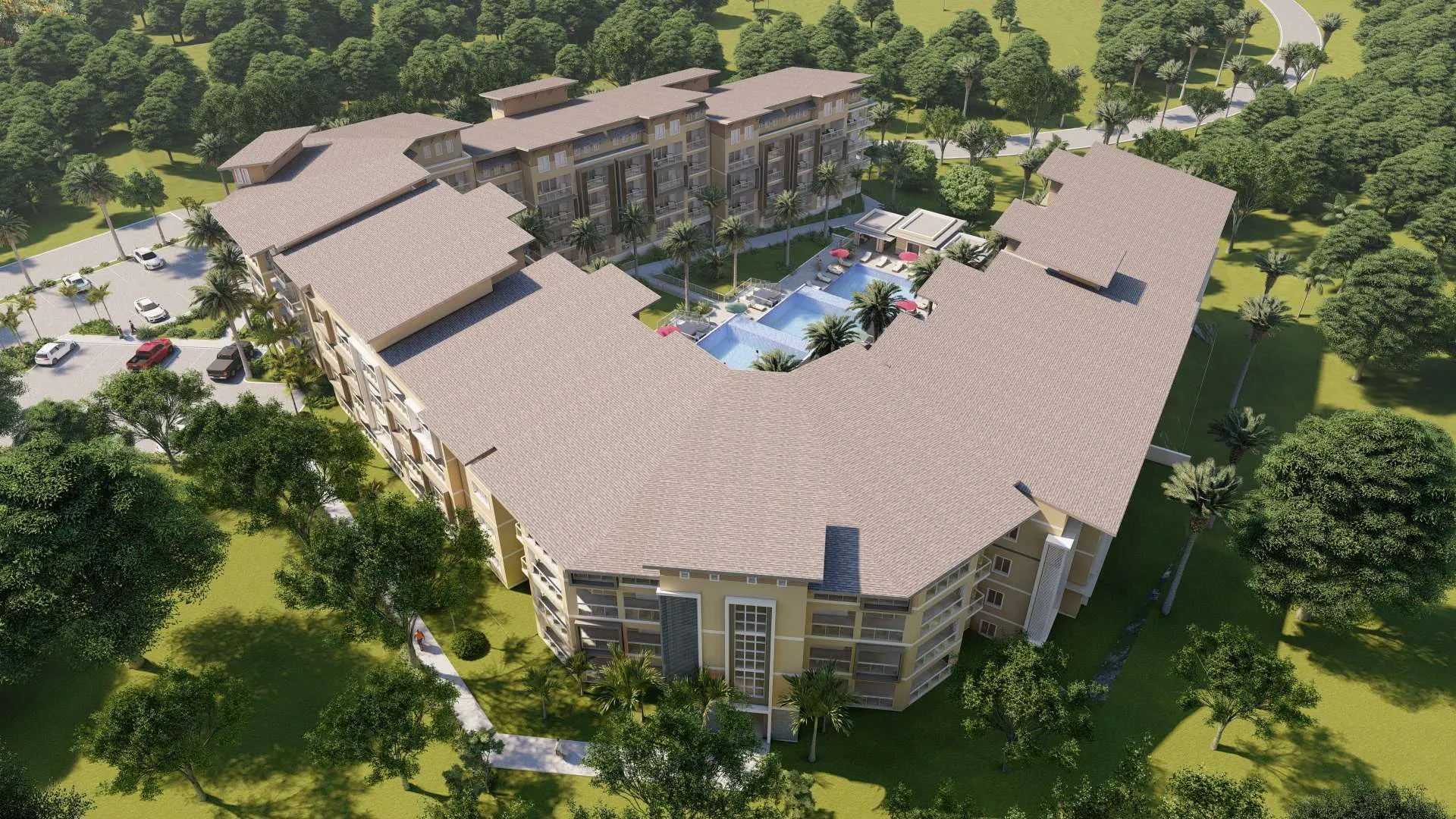 buyDRproperty Aerial view of a luxury resort with a central pool, surrounded by lush green trees and parking. Sosua Real Estate