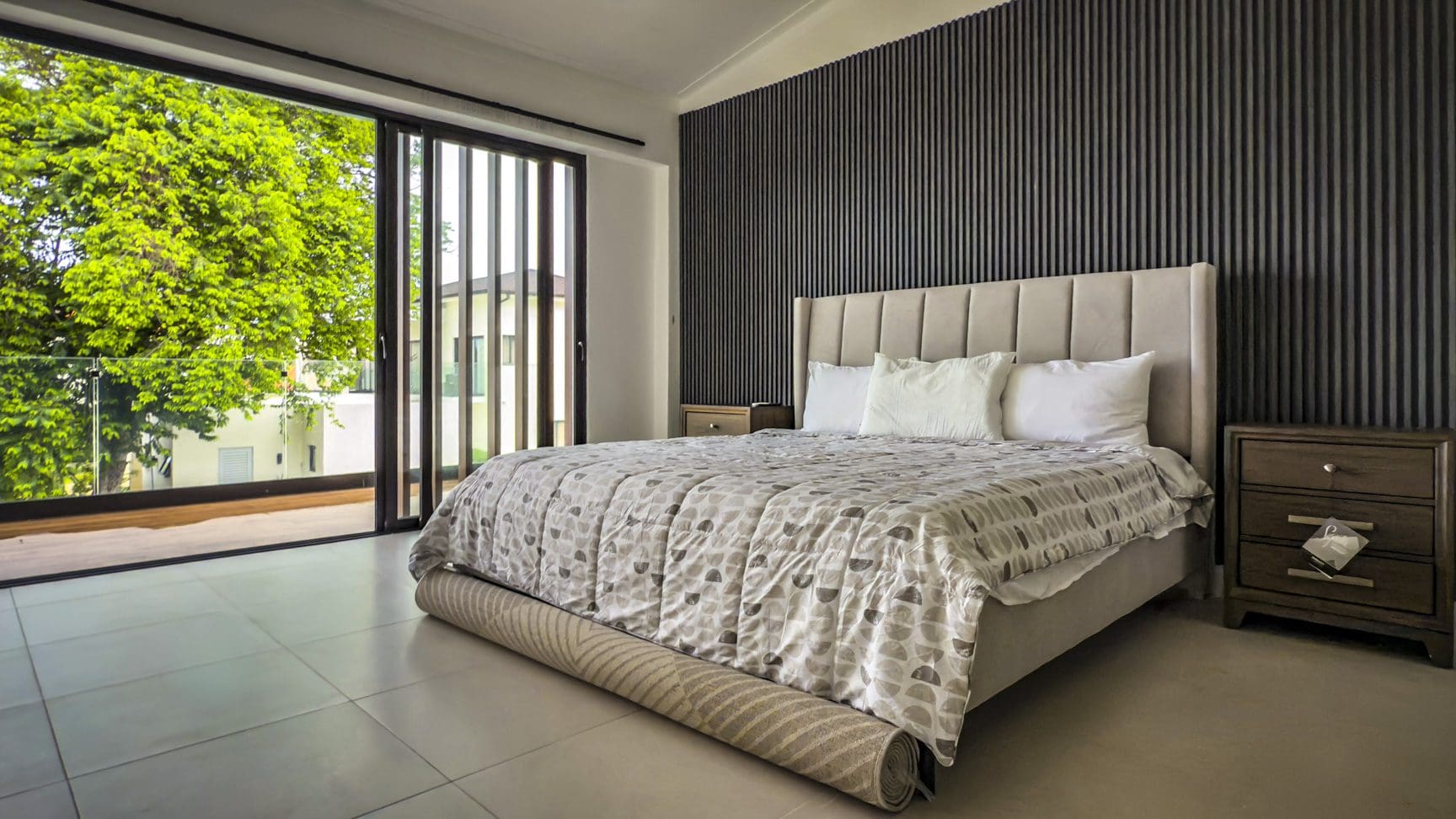 buyDRproperty Luxury bedroom in Sosua Ocean Village villa with sliding doors to a balcony and garden view. Sosua Real Estate