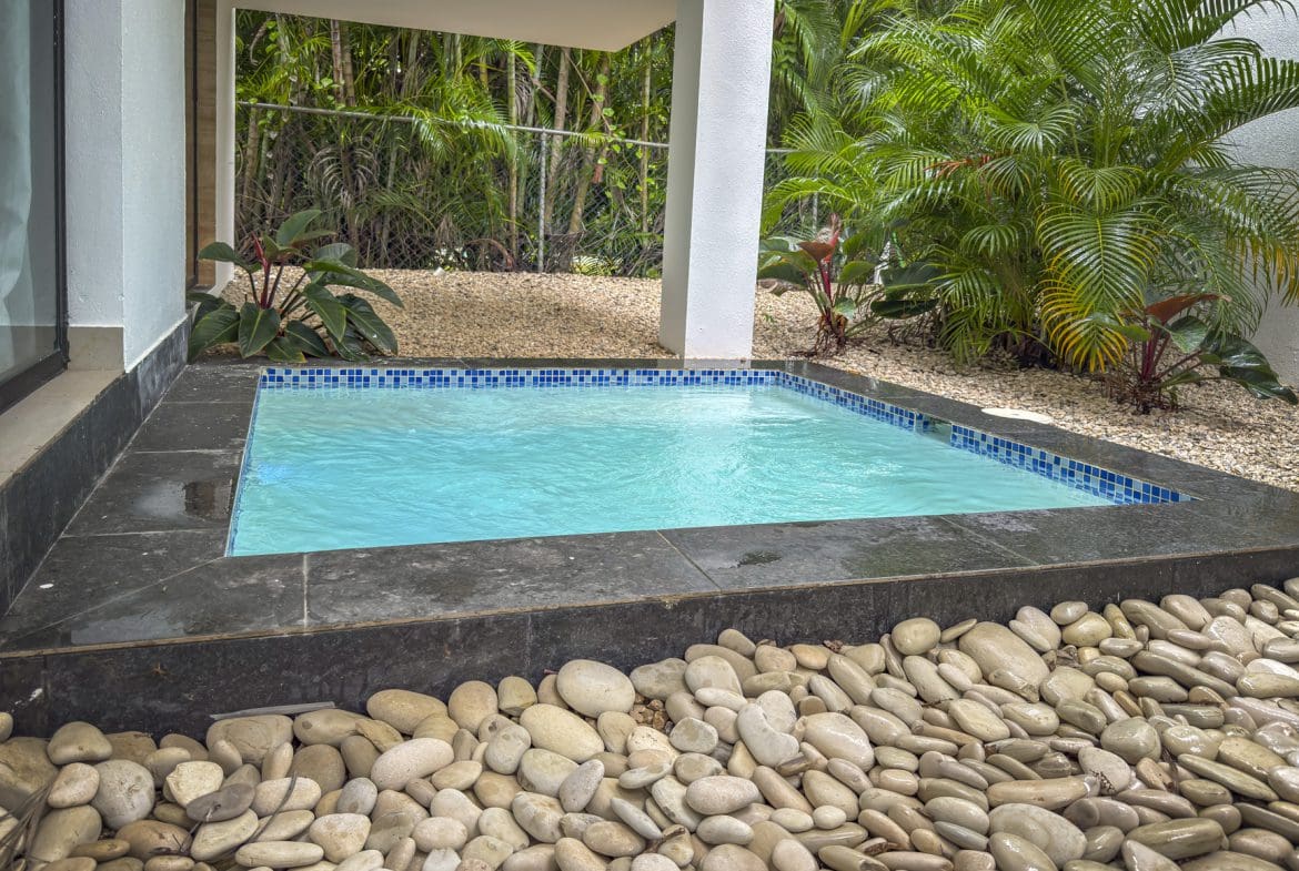 buyDRproperty Luxury villa splash pool with pebble surround and tropical landscaping. Sosua Real Estate