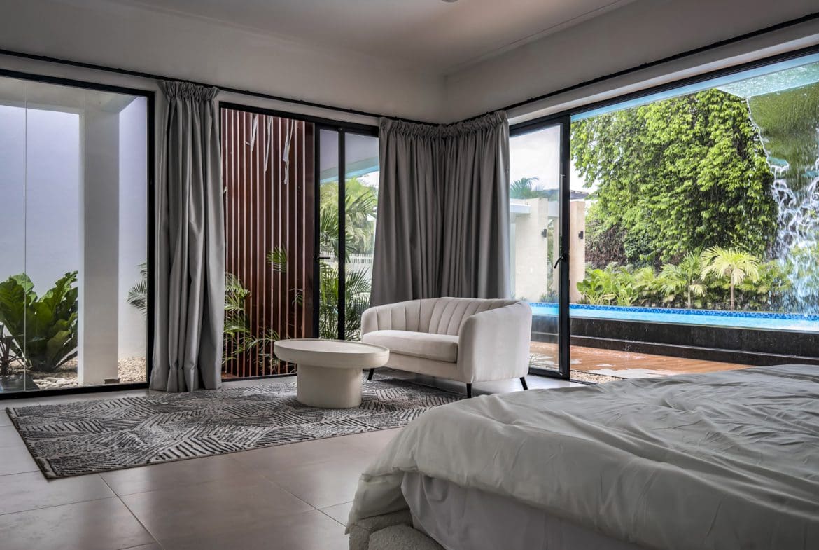 buyDRproperty Luxury villa bedroom with pool view in Sosua Ocean Village Sosua Real Estate
