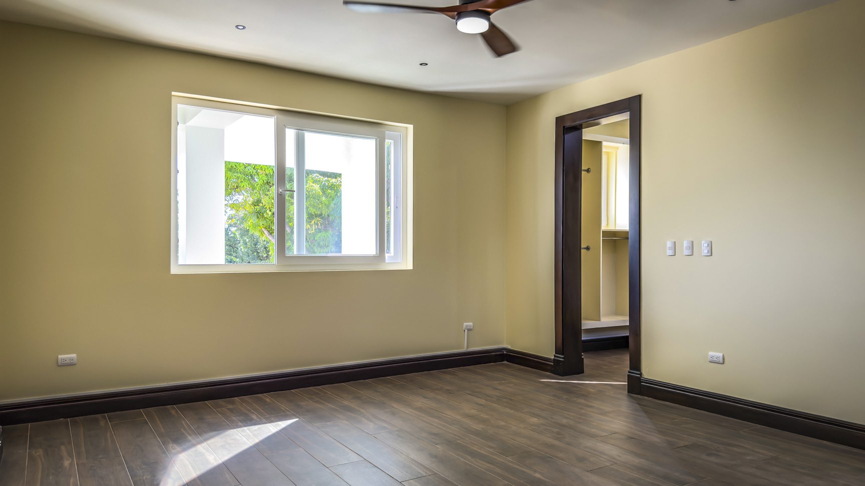 buyDRproperty Bedroom in La Mulata villa for sale with hardwood floors, window, and door to another room. Sosua Real Estate