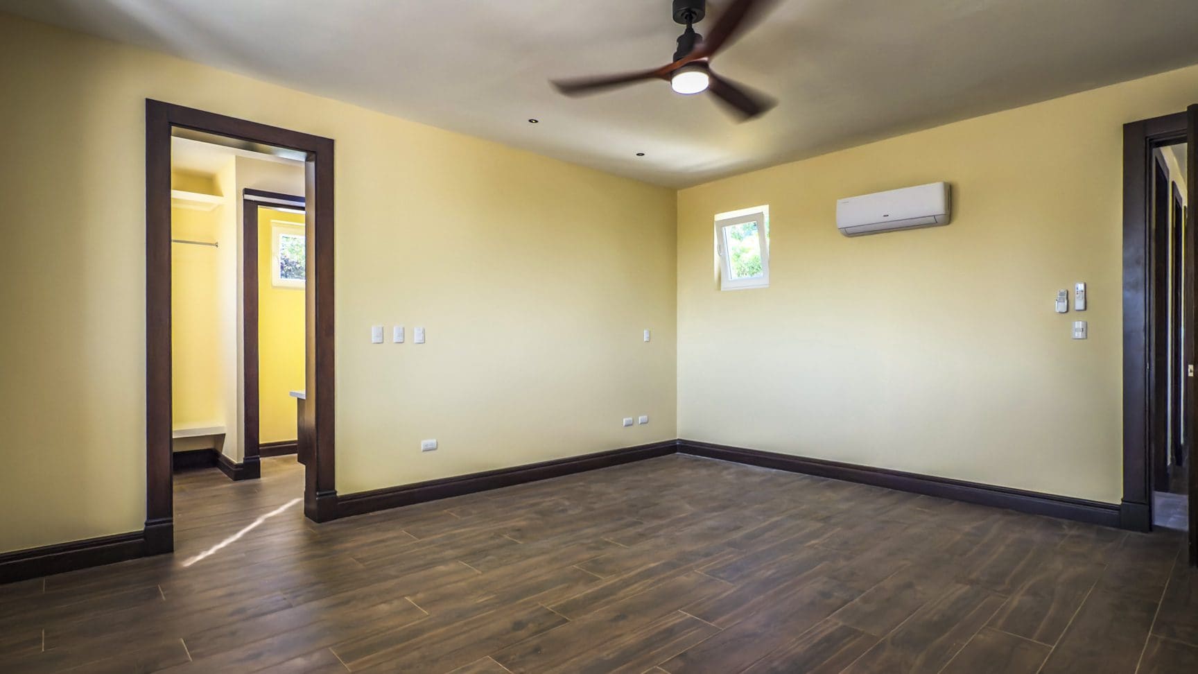 buyDRproperty Bedroom interior of 3 bedroom villa for sale in La Mulata, with hardwood floors and dark wood trim. Sosua Real Estate