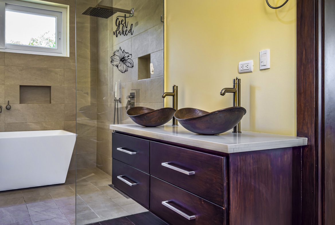 buyDRproperty Bathroom with double sink, walk-in shower, and modern bathtub in La Mulata villa. Sosua Real Estate