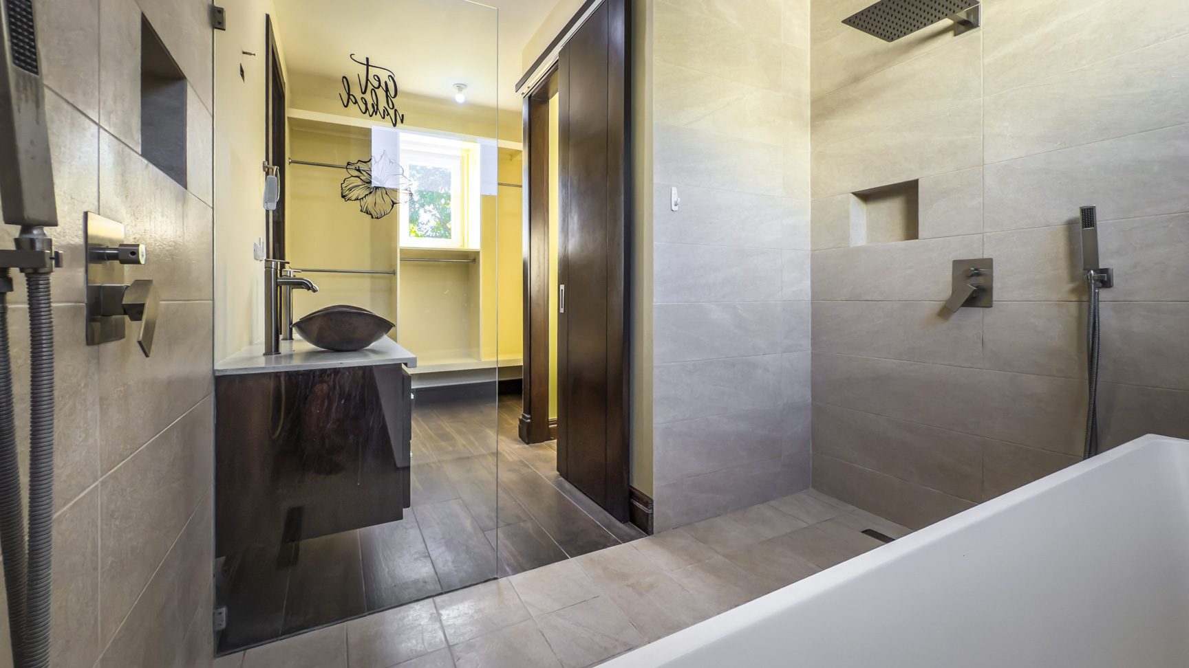 buyDRproperty Modern bathroom with walk-in shower, vanity, and closet in La Mulata villa. Sosua Real Estate
