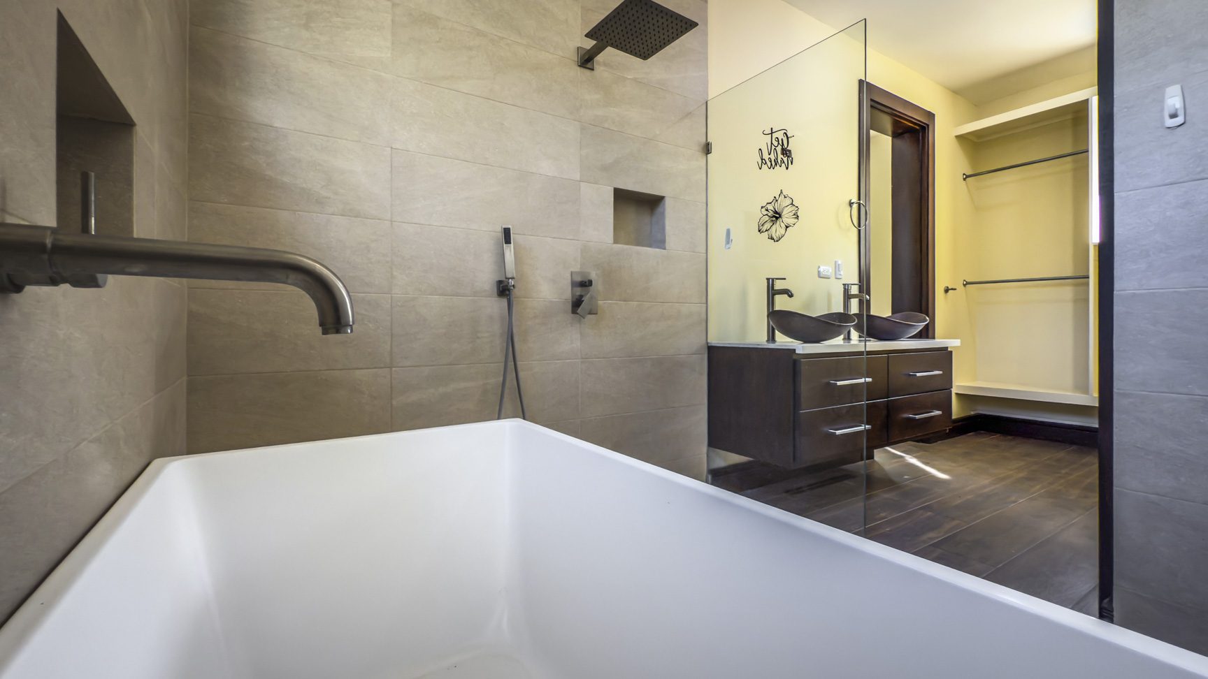 buyDRproperty Modern bathroom with tub, shower, double vanity, and walk-in closet in La Mulata villa. Sosua Real Estate