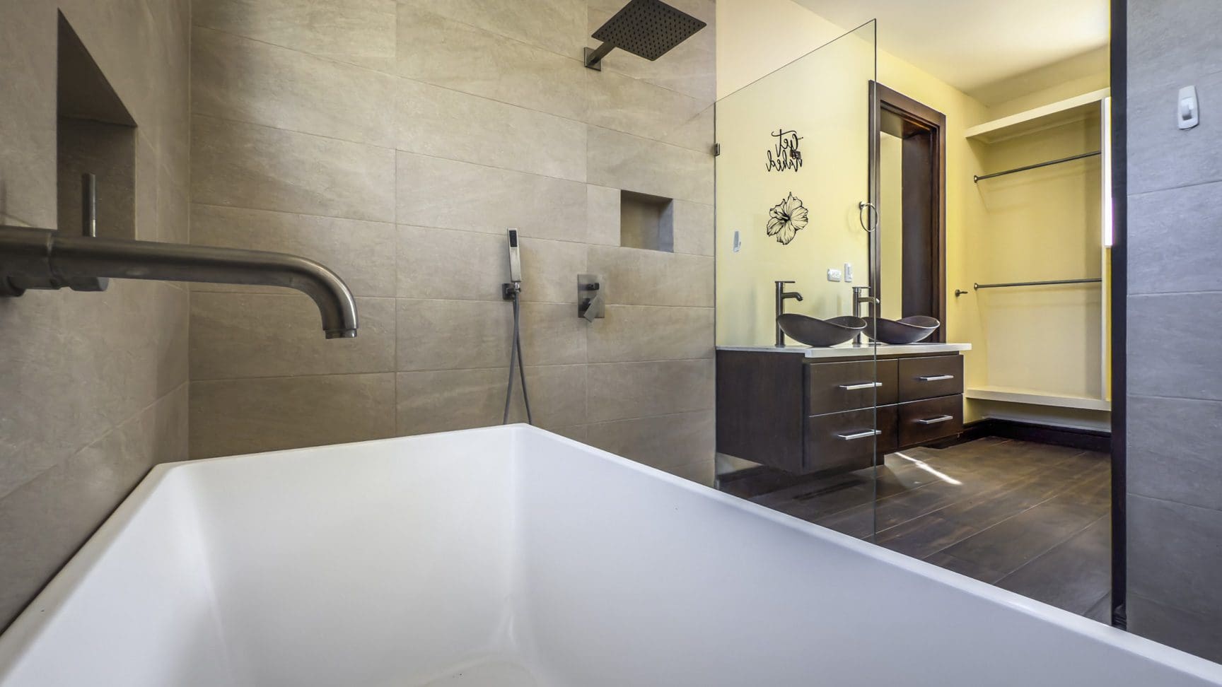 buyDRproperty Modern bathroom with tub, shower, double vanity, and walk-in closet in La Mulata villa. Sosua Real Estate