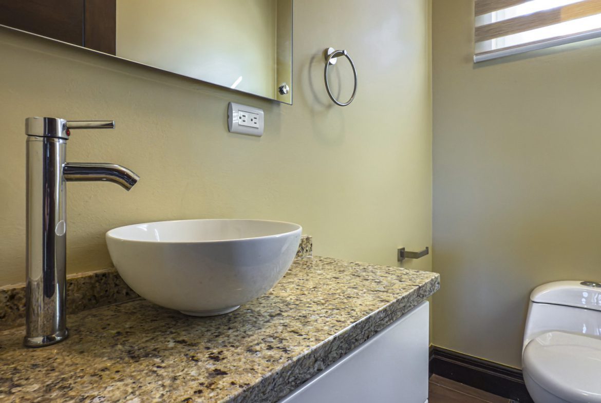 buyDRproperty Modern bathroom with vessel sink, granite countertop, and toilet. For sale villa in La Mulata. Sosua Real Estate