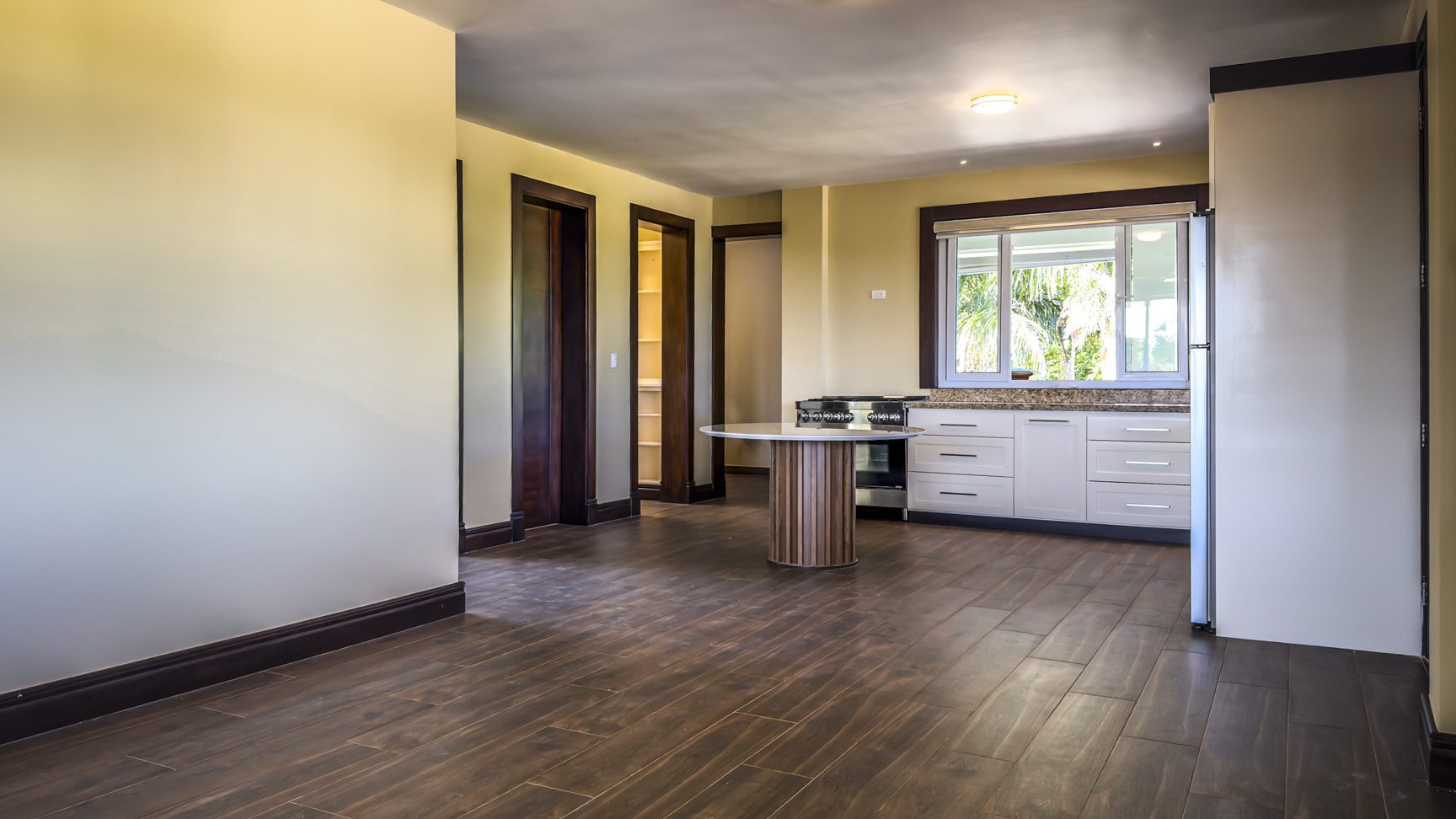 buyDRproperty Interior view of a 3 bedroom villa in La Mulata, showcasing kitchen and dining area with wood floors. Sosua Real Estate
