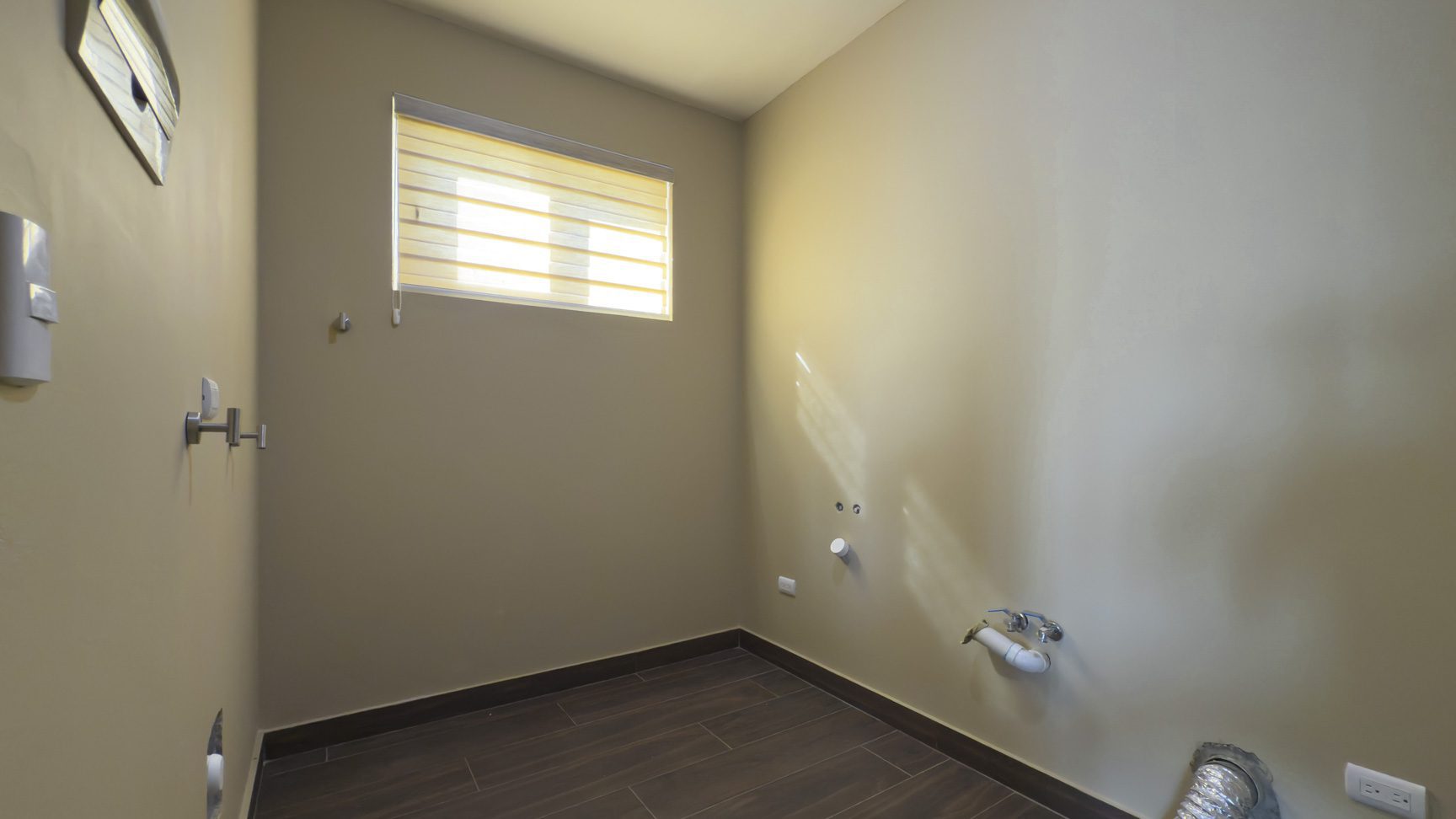 buyDRproperty Empty laundry room with window, tile floor, and utility connections. Villa in La Mulata. Sosua Real Estate