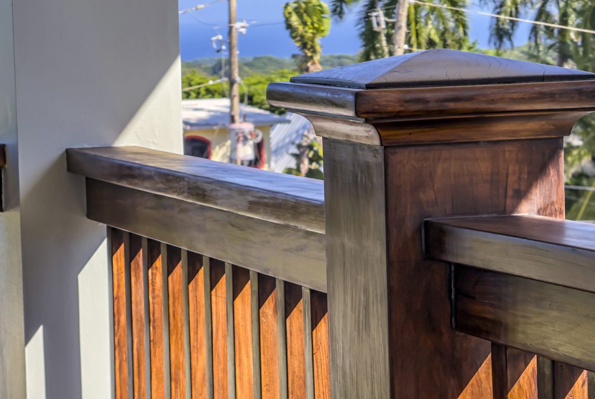 buyDRproperty Detail of wooden railing in La Mulata villa, showcasing design and outdoor view. For Sale! Sosua Real Estate