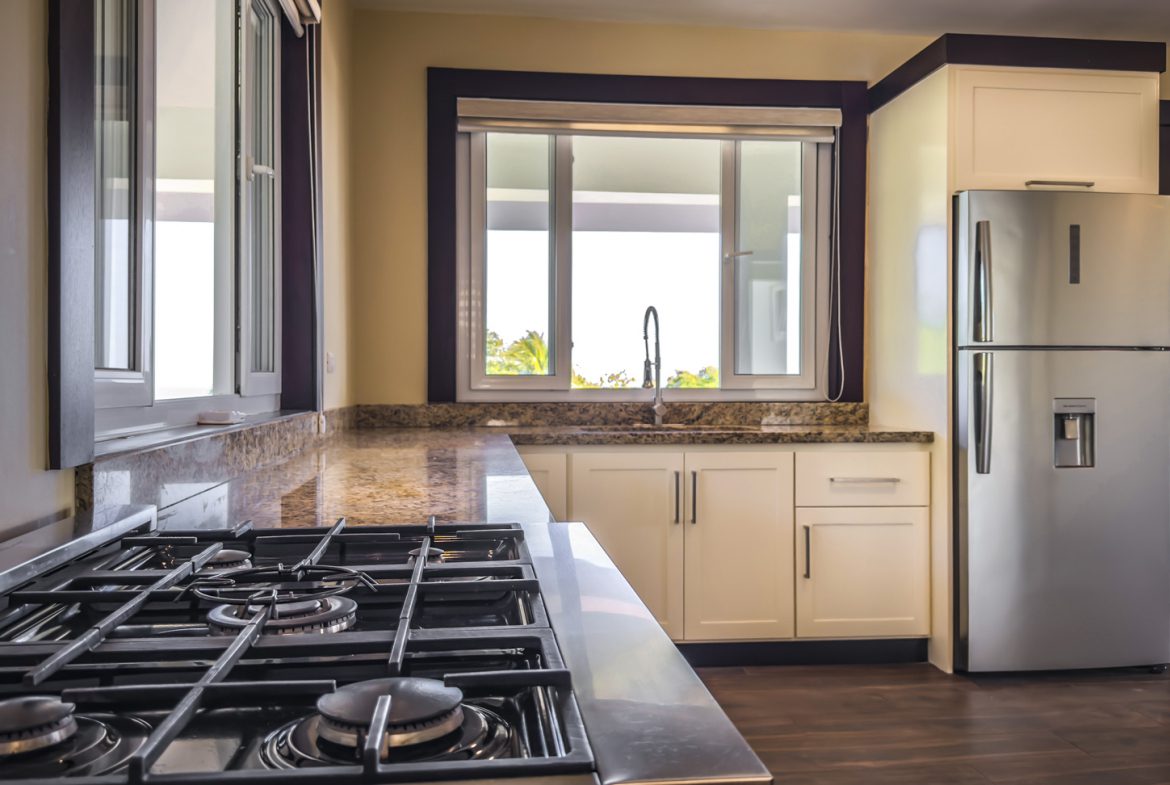 buyDRproperty Modern kitchen with stainless steel appliances in La Mulata villa. Sosua Real Estate