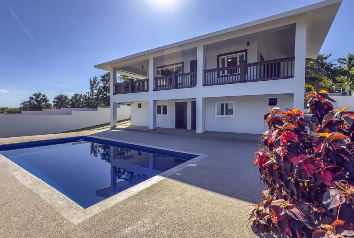 buyDRproperty La Mulata villa with a pool for sale. Modern 3-bedroom home exterior view. Sosua Real Estate