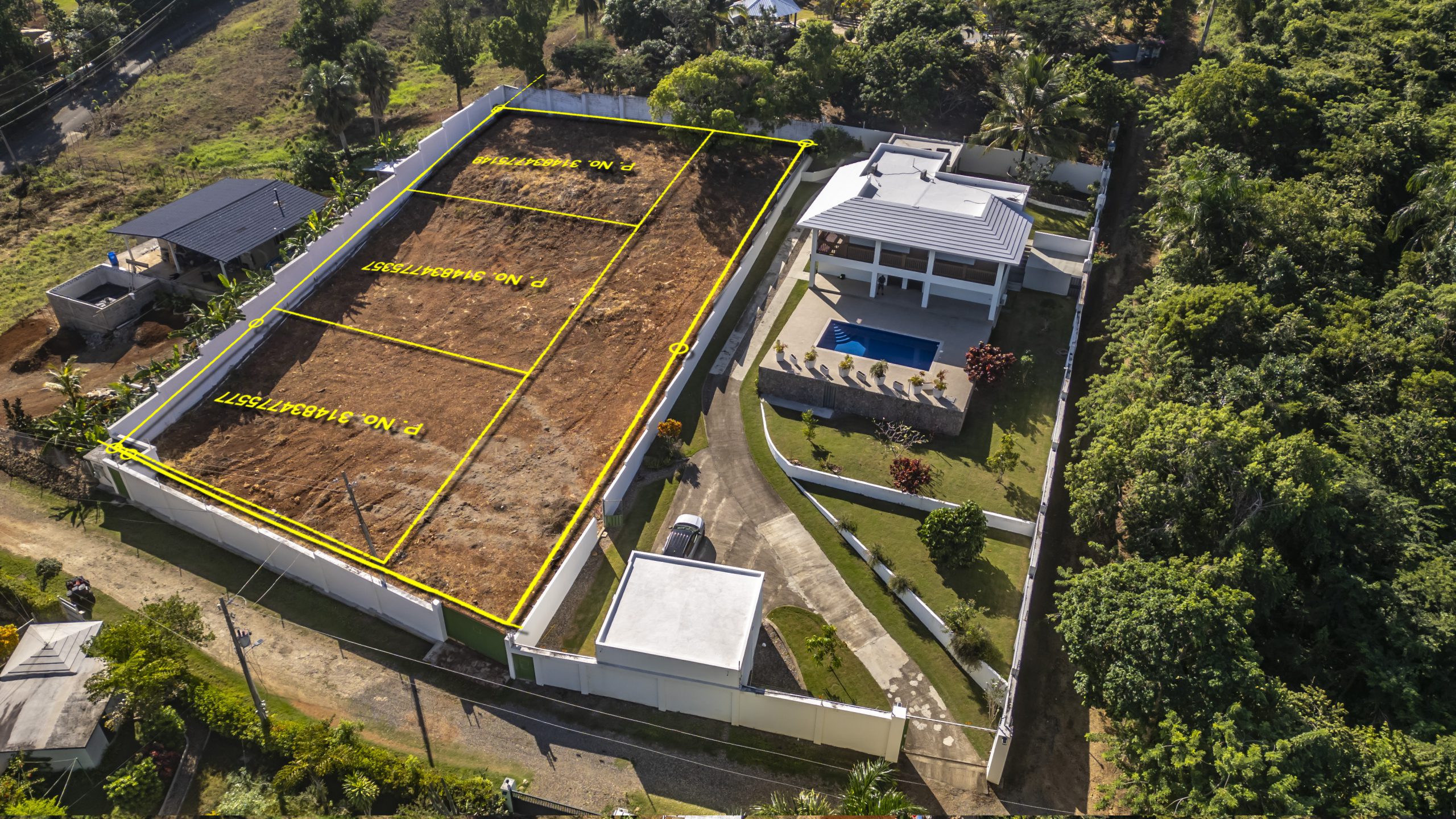 buyDRproperty Aerial view of La Mulata villa for sale with pool and marked land lots. Sosua Real Estate