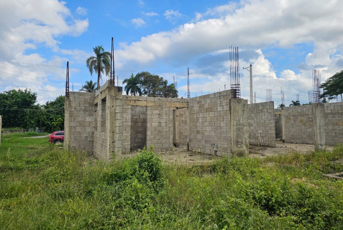 buyDRproperty Construction started on a lot near Sosúa, showing cinder block walls and rebar for future development. Sosua Real Estate
