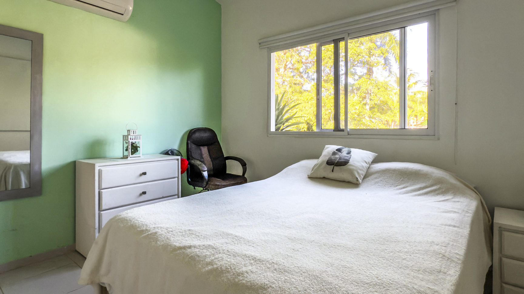 buyDRproperty Bright bedroom in a Colibri villa with a window, bed, and dresser. Sosua Real Estate