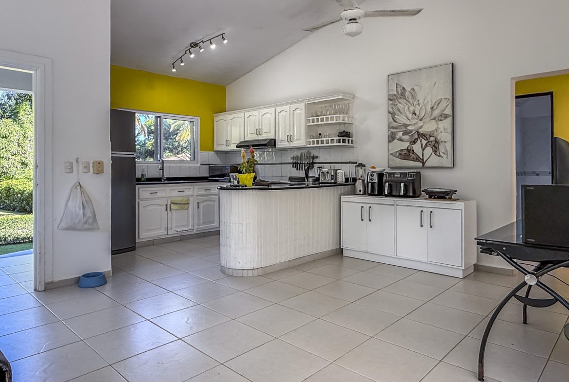 buyDRproperty Bright kitchen in Colibri villa with white cabinets and tile floor, part of a tropical oasis. Sosua Real Estate