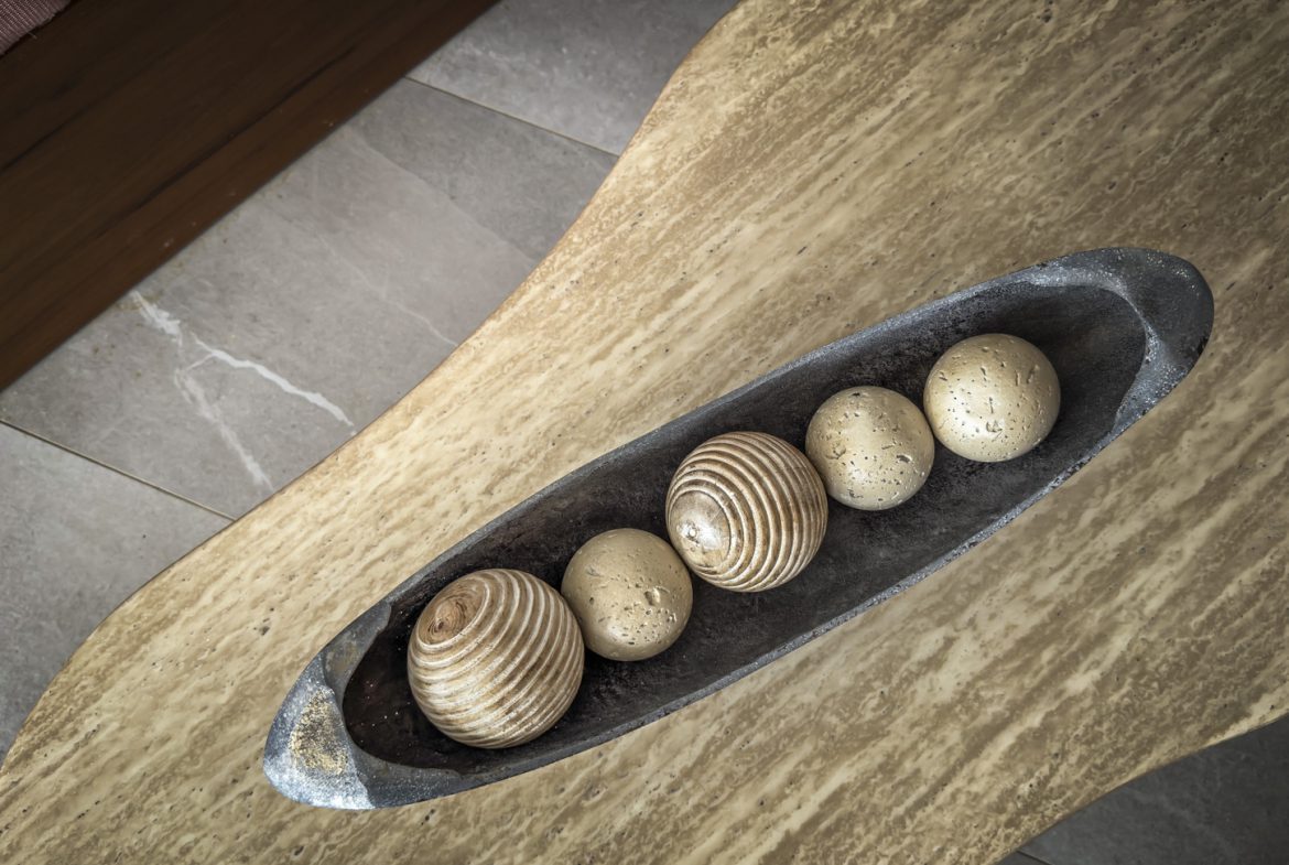 buyDRproperty Decorative balls in a rustic bowl on a marble coffee table. Sosua Real Estate
