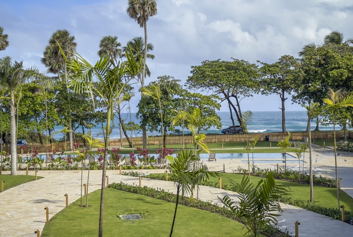 buyDRproperty Lush Dominican Republic resort with pools, palm trees, and ocean view. Sosua Real Estate