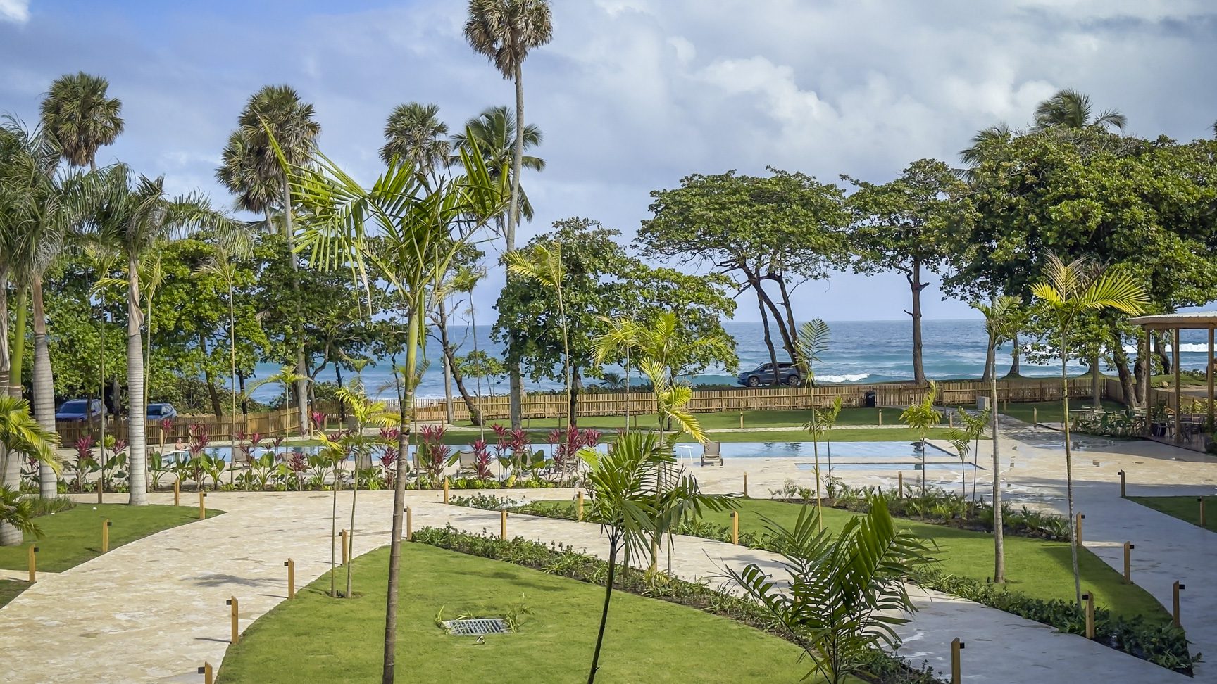 buyDRproperty Lush Dominican Republic resort with pools, palm trees, and ocean view. Sosua Real Estate