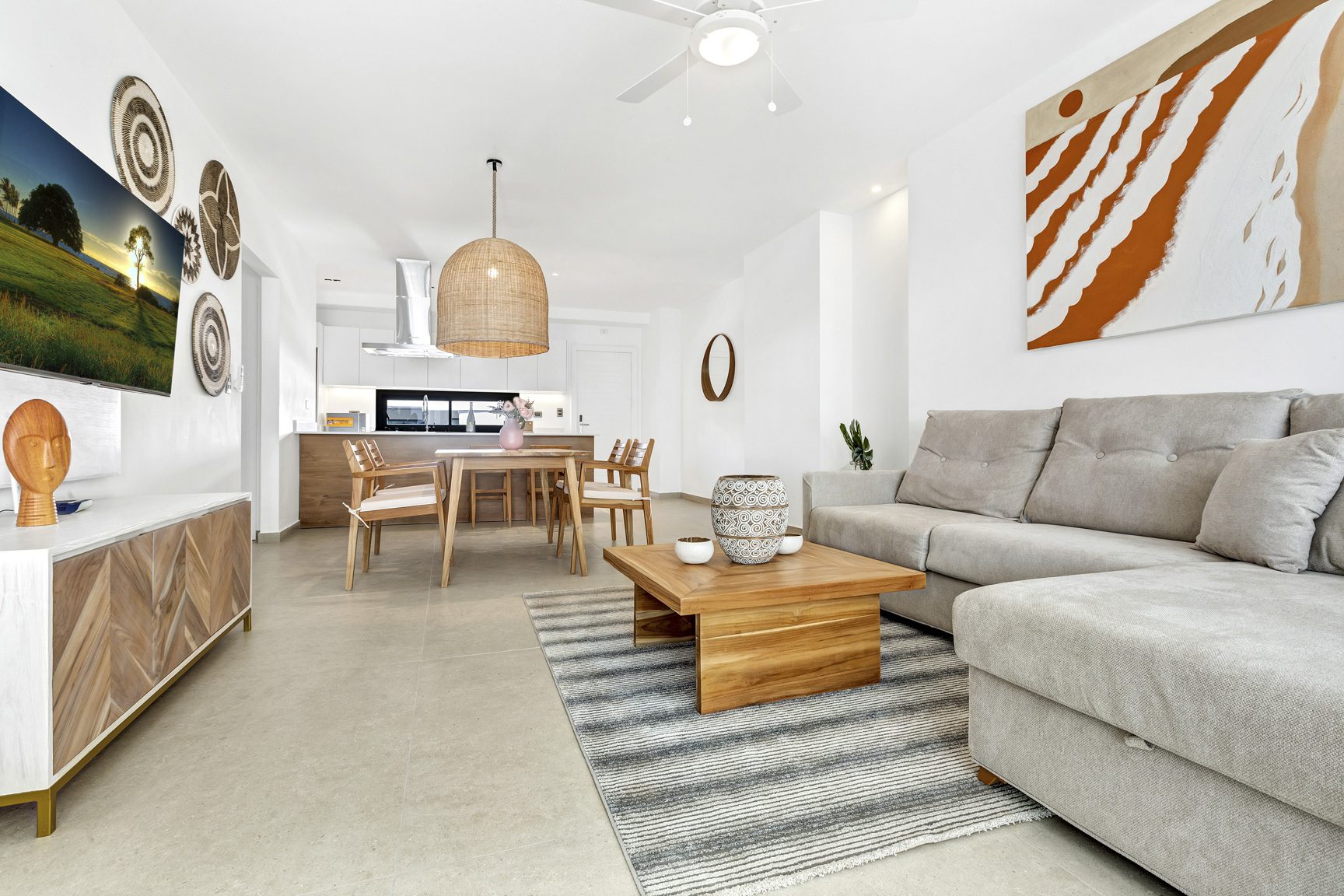 buyDRproperty Bright, open-plan living room with a sectional sofa, dining area, and a TV. Sosua Real Estate