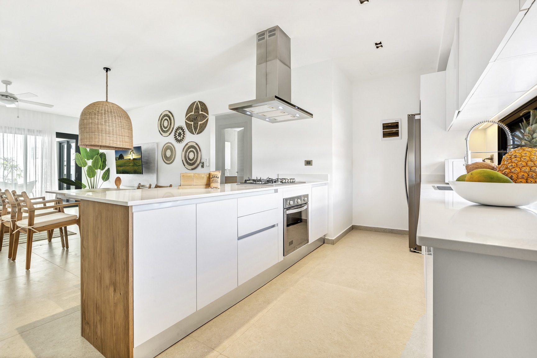 buyDRproperty Modern kitchen with white cabinets, wooden island, and stainless steel appliances Sosua Real Estate