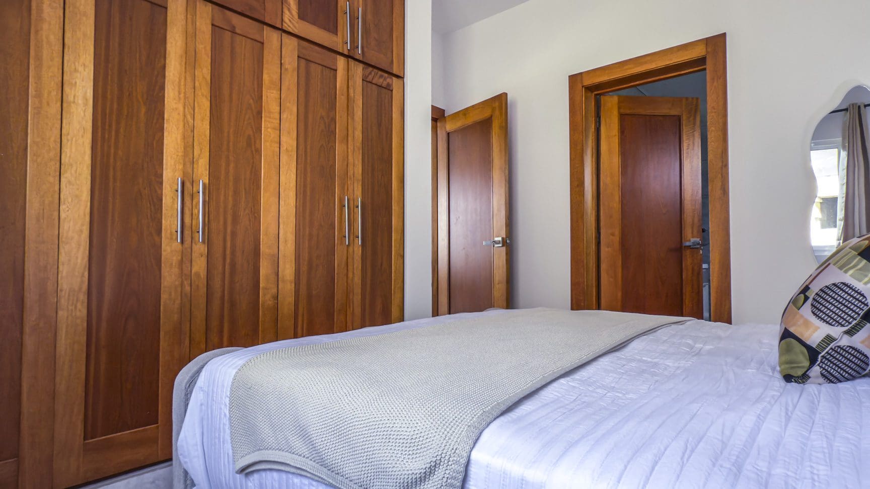 buyDRproperty Bedroom with modern closet, bed, and storage. Closet design for bedroom storage. Sosua Real Estate