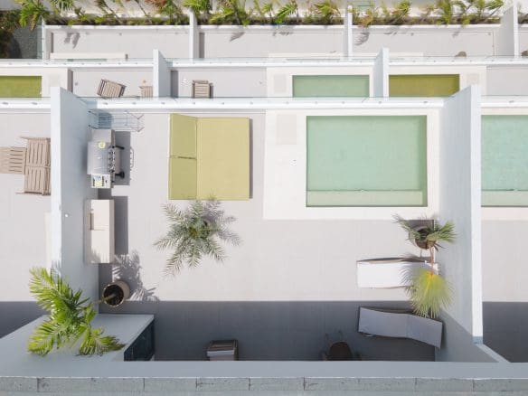 buyDRproperty Aerial view of a modern rooftop terrace with pool, lounge area, and lush greenery. Sosua Real Estate