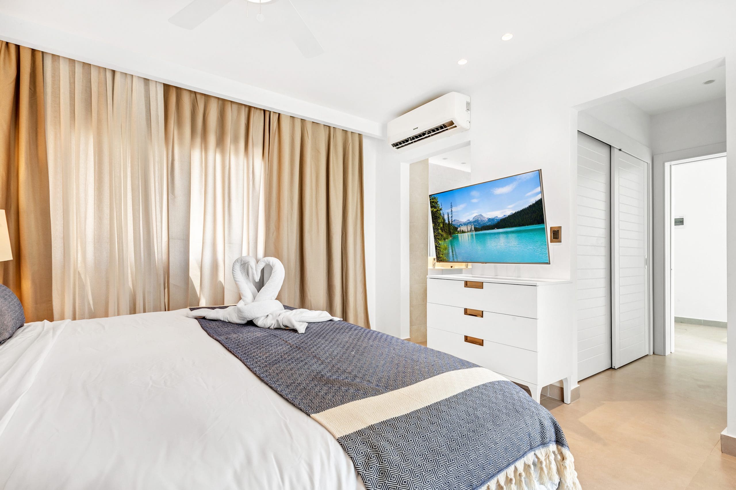 buyDRproperty Luxury beachfront villa bedroom with swan towel art Sosua Real Estate