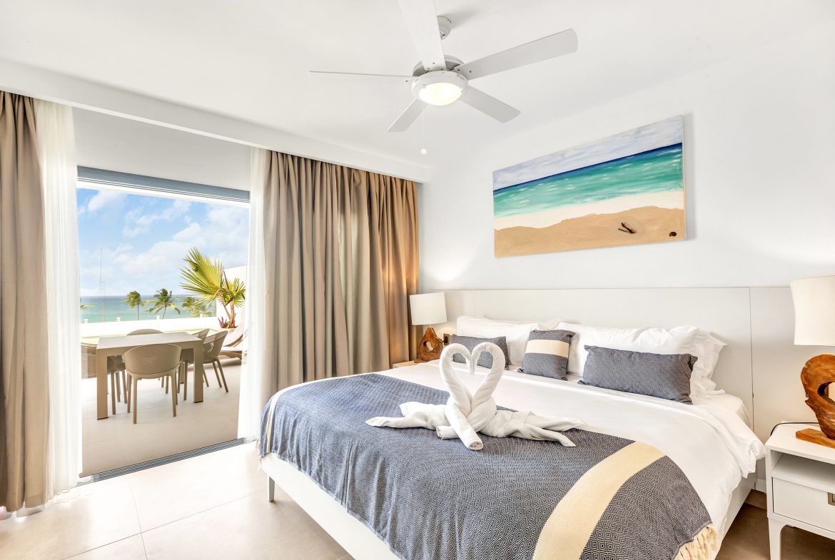 buyDRproperty Luxury bedroom with ocean view and towel swans on bed Sosua Real Estate