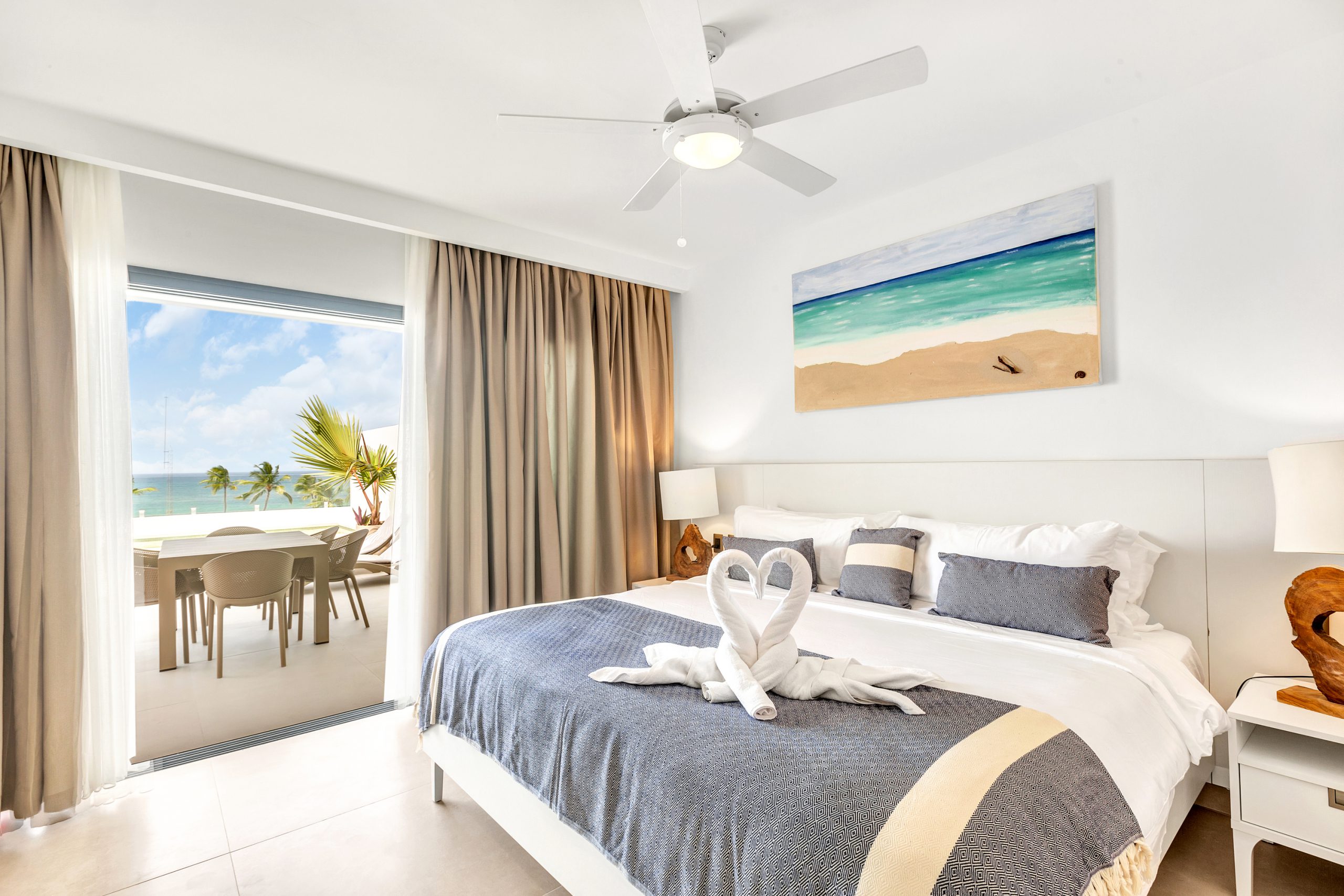 buyDRproperty Luxury bedroom with ocean view and towel swans on bed Sosua Real Estate