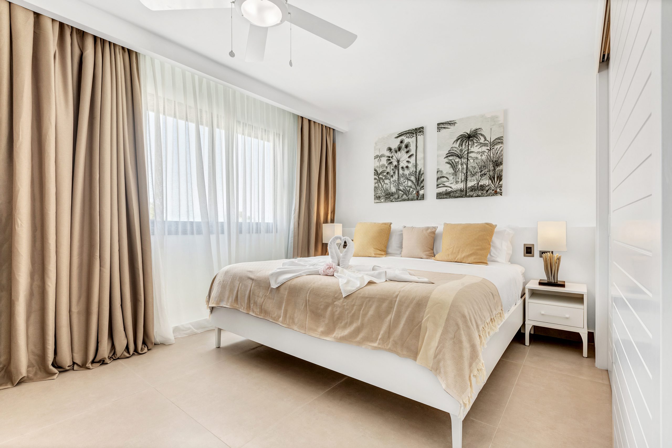 buyDRproperty Light and airy coastal bedroom with tropical decor and white bed. Sosua Real Estate