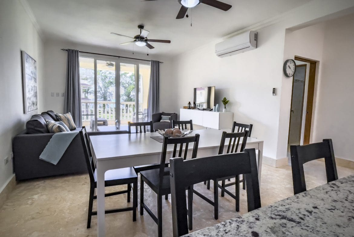 buyDRproperty Bright living room with modern furniture, ceiling fans, and a dining area Sosua Real Estate