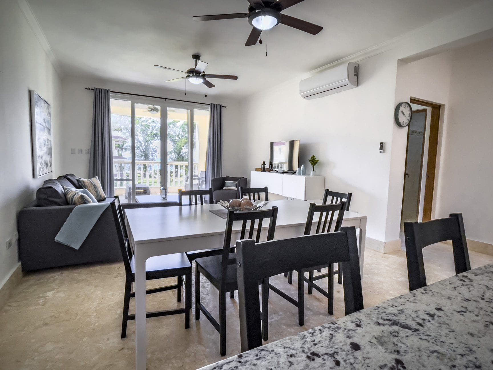 buyDRproperty Bright living room with modern furniture, ceiling fans, and a dining area Sosua Real Estate