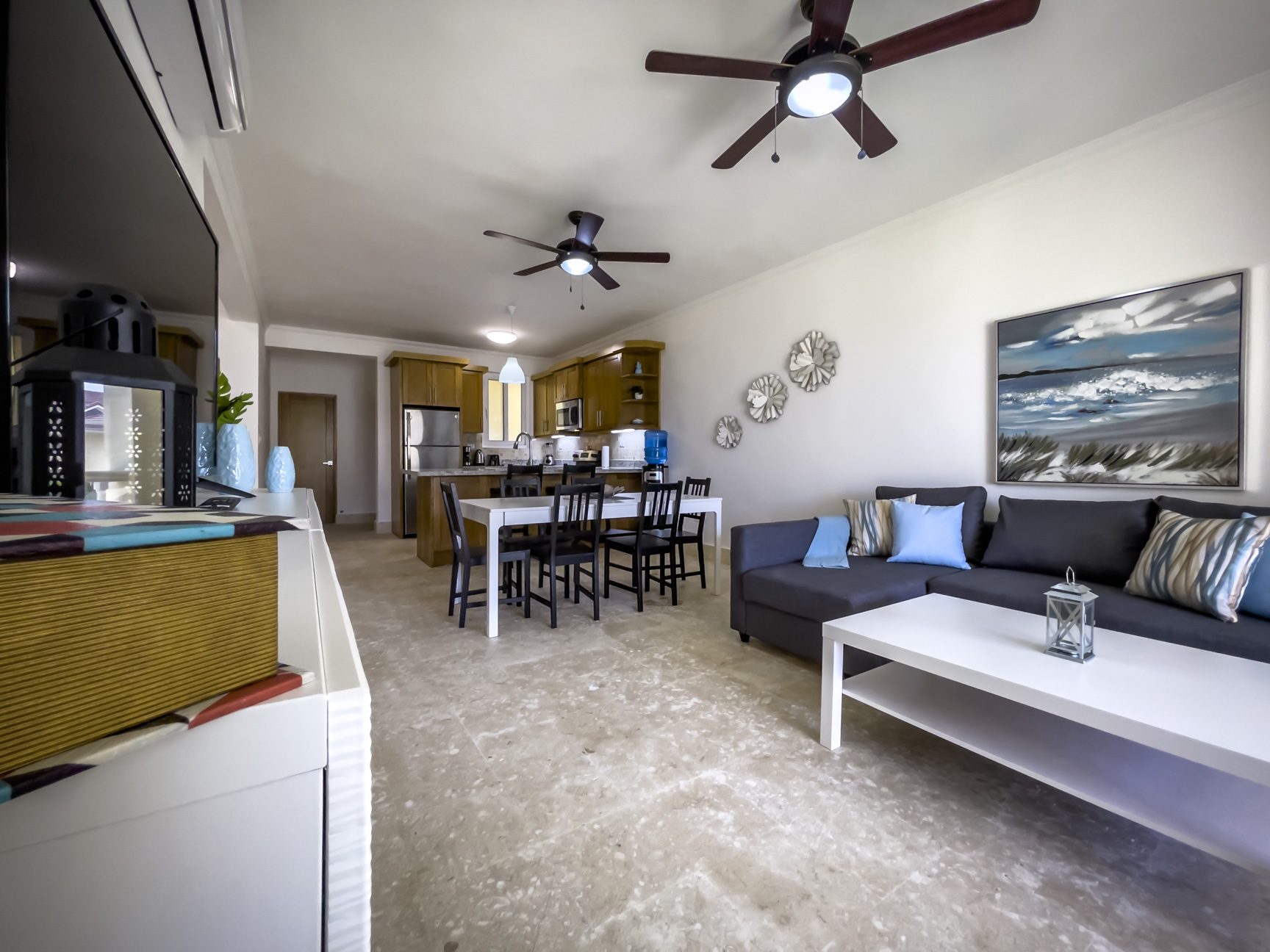 buyDRproperty Open-concept living room with kitchen, dining area, and comfortable seating, perfect for a relaxing vacation. Sosua Real Estate