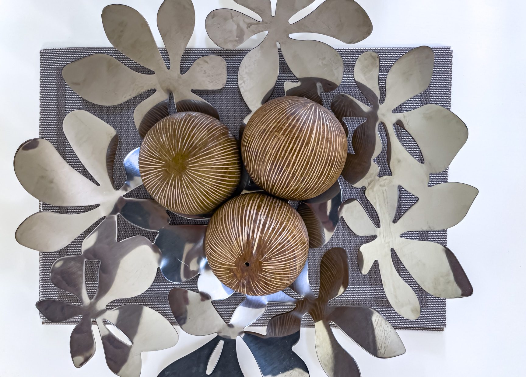 buyDRproperty Decorative centerpiece with brown striped spheres and silver flower accents on a gray placemat. Sosua Real Estate