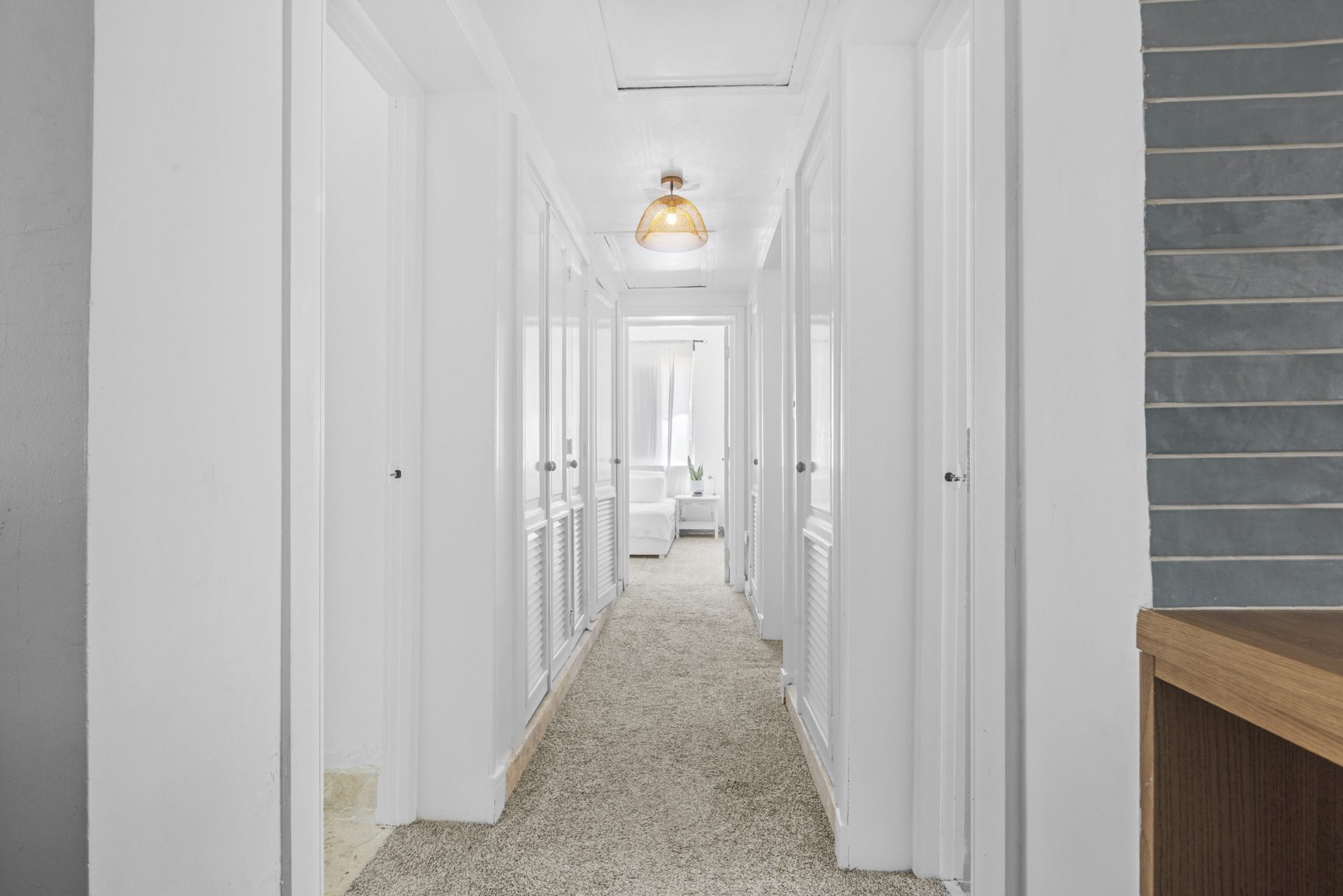 buyDRproperty Bright hallway with white walls, closet doors, and beige carpet. A warm, inviting space. Sosua Real Estate