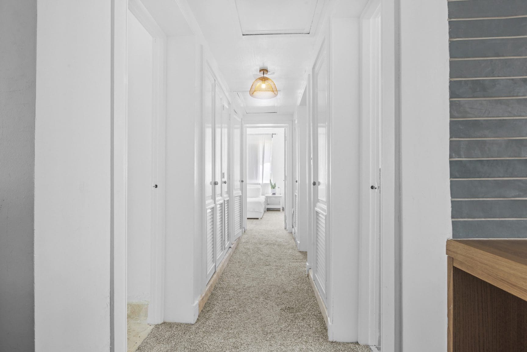 buyDRproperty Bright hallway with white walls, closet doors, and beige carpet. A warm, inviting space. Sosua Real Estate