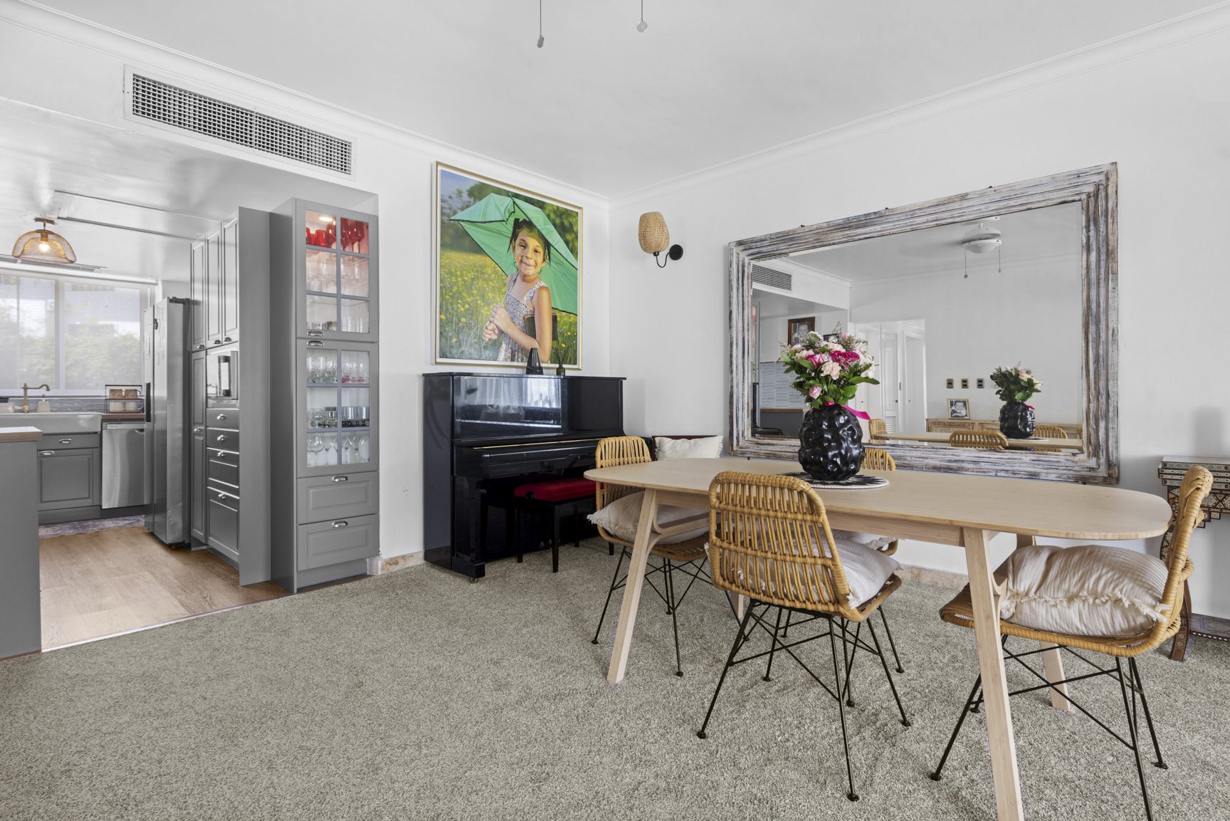 buyDRproperty Dining room with piano, mirror, table, and chairs. Artwork adds a personal touch to this stylish interior. Sosua Real Estate