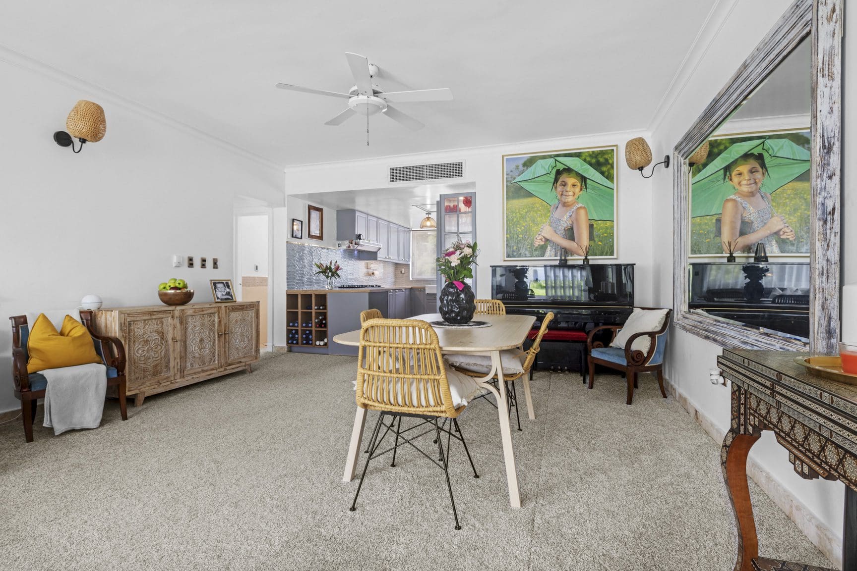 buyDRproperty Bright living area with dining table, piano, artwork, and neutral carpet. Sosua Real Estate