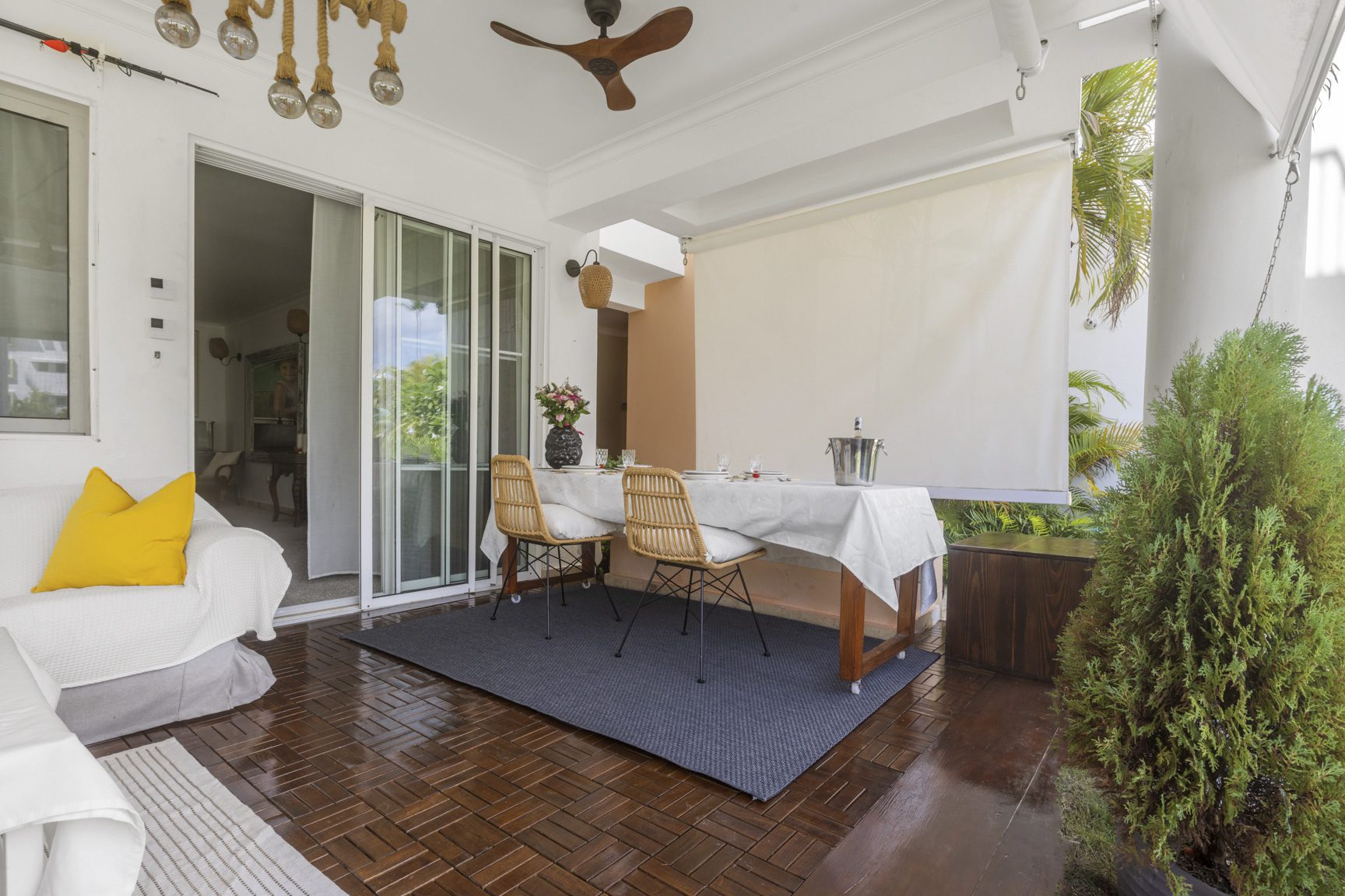 buyDRproperty Cozy outdoor dining area with table, chairs, and a lounge sofa. Sosua Real Estate