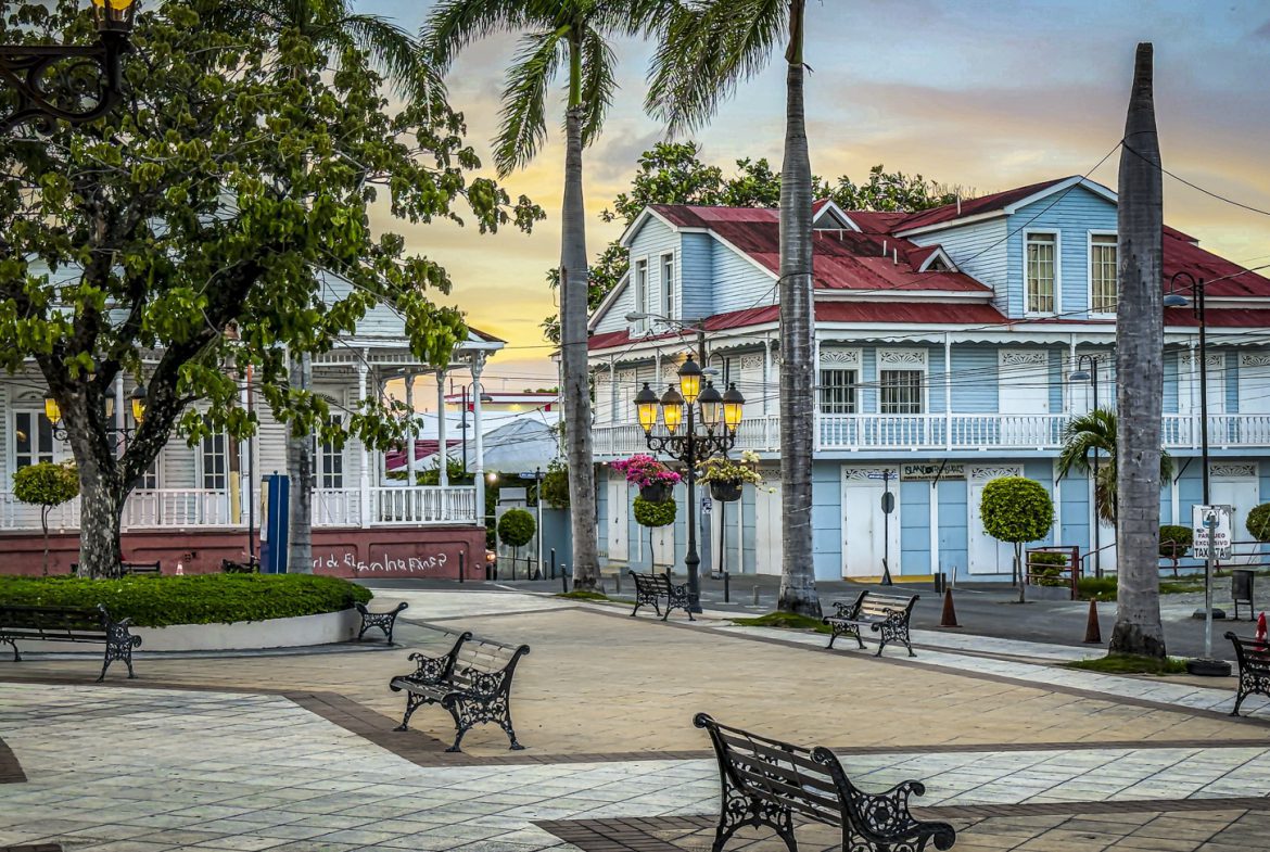 buyDRproperty Picturesque square with benches and colorful colonial architecture in Puerto Plata, Dominican Republic. Sosua Real Estate