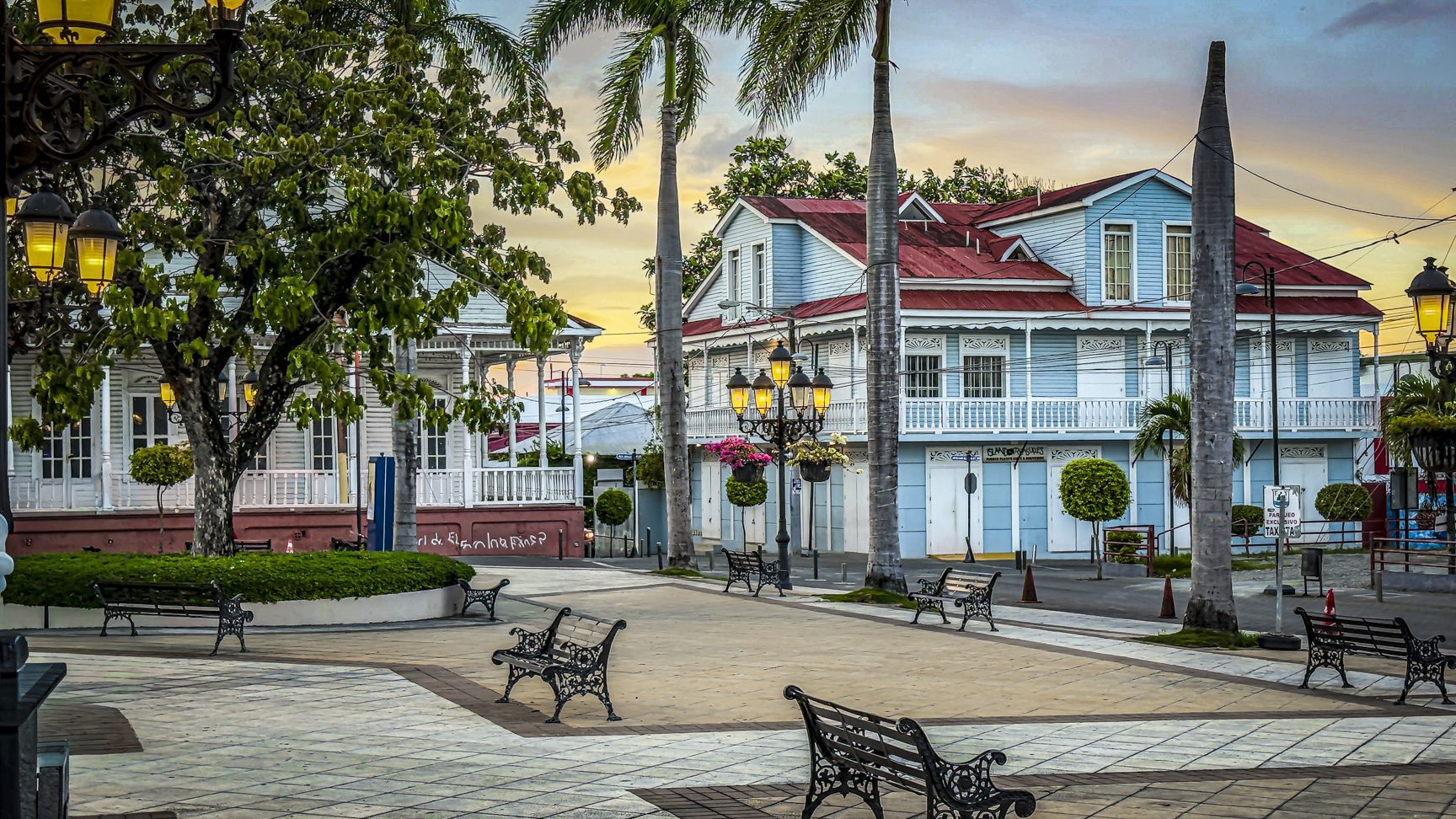 buyDRproperty Picturesque square with benches and colorful colonial architecture in Puerto Plata, Dominican Republic. Sosua Real Estate