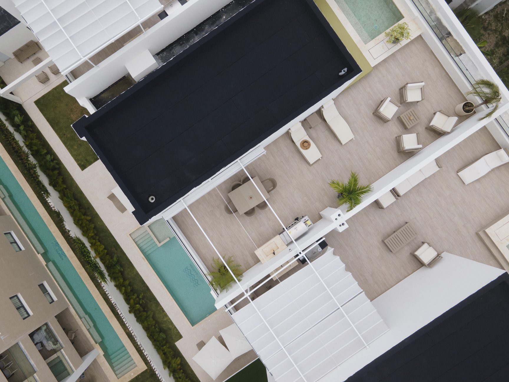 buyDRproperty Luxury rooftop terrace with pool, dining area, and lounge chairs. Sosua Real Estate