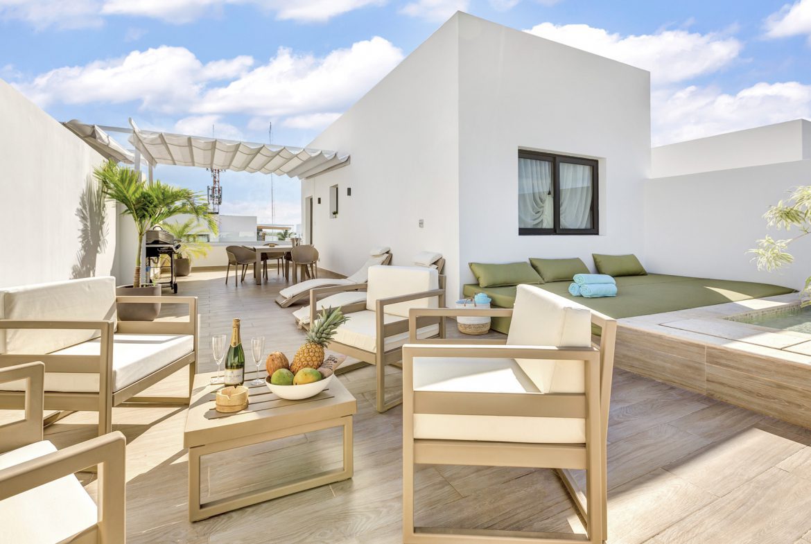 buyDRproperty Modern rooftop terrace with lounge chairs, small pool, and tropical decor Sosua Real Estate