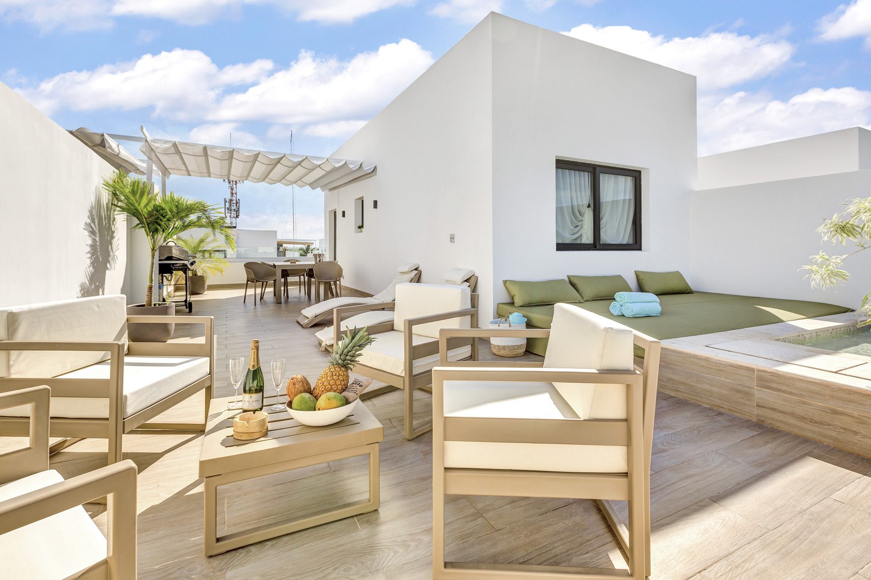 buyDRproperty Modern rooftop terrace with lounge chairs, small pool, and tropical decor Sosua Real Estate