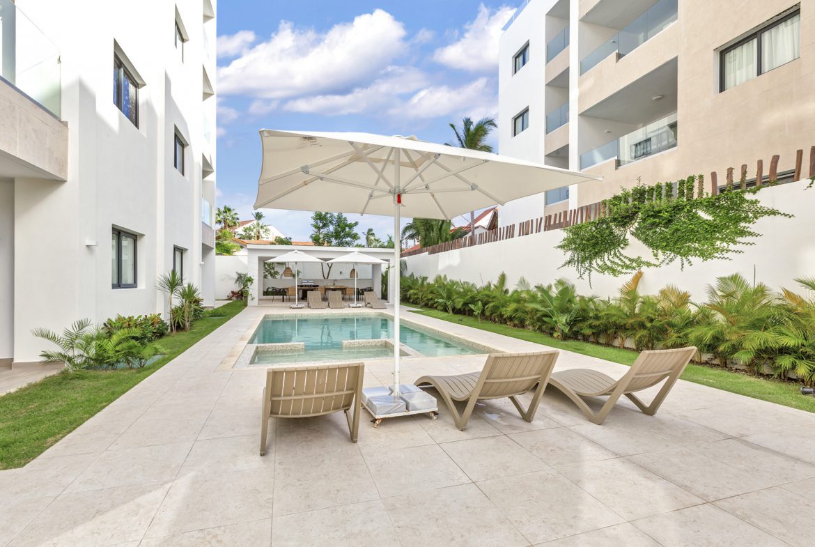 buyDRproperty Eco-friendly green cleaning products on a wooden table in a sustainable home. Sosua Real Estate