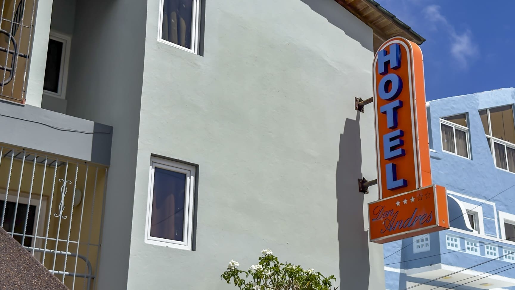 buyDRproperty Orange "HOTEL Don Andres" sign on a light blue building Sosua Real Estate