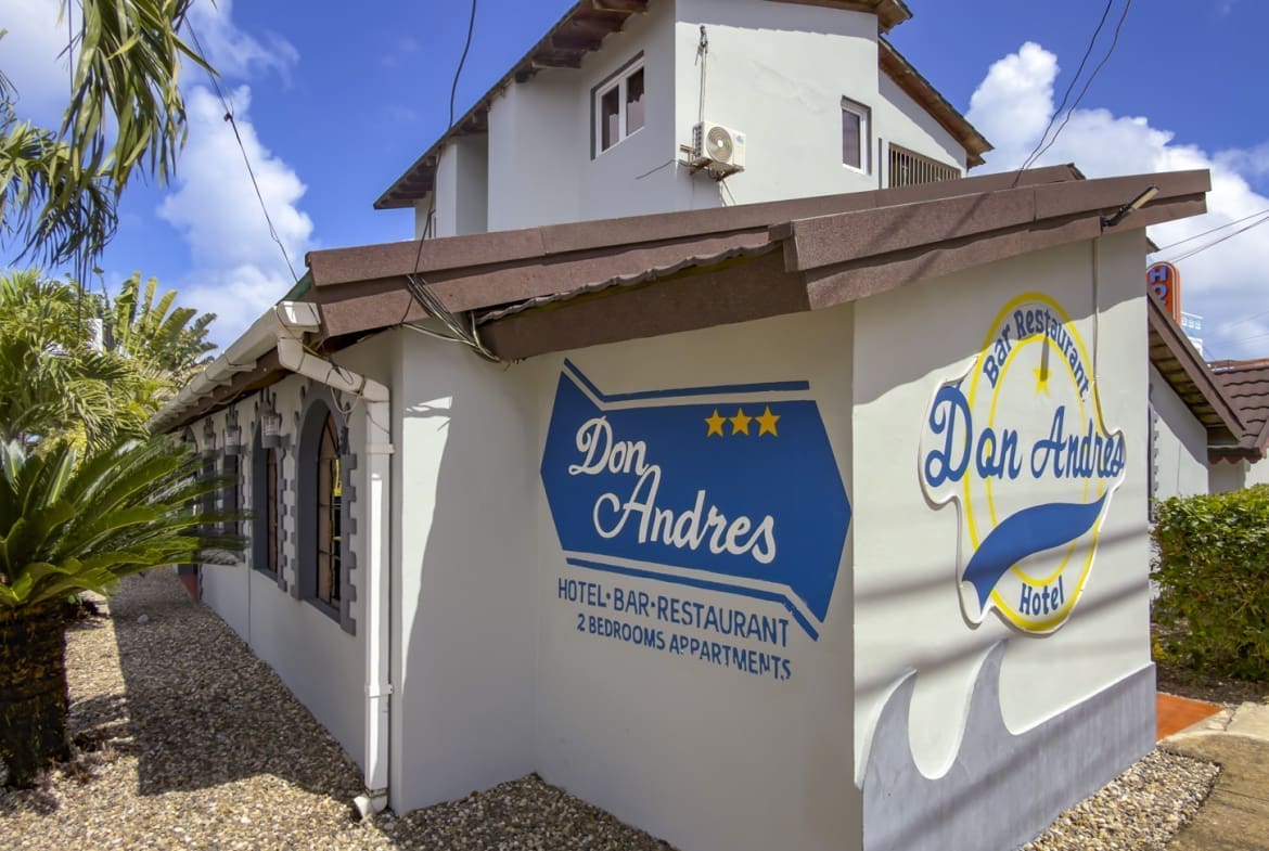 buyDRproperty Don Andres Hotel, Bar & Restaurant in Aruba: exterior view of the building with signage. Sosua Real Estate